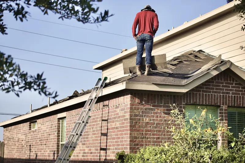 Professional roofer working on a residential roof in Edgemont Park